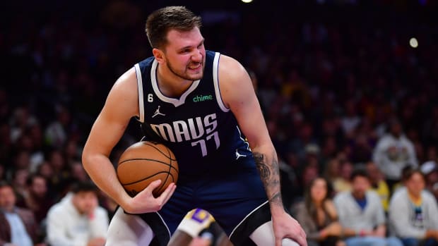 Dallas Mavericks superstar Luka Doncic grimaces after pulling down a rebound during the 2022-23 NBA season.